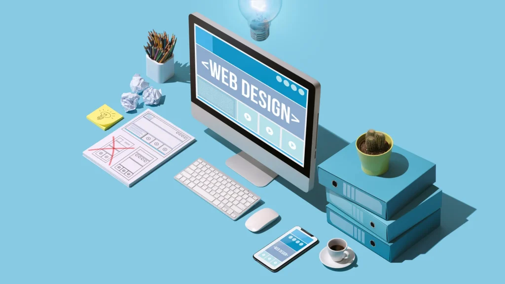 A workspace with computer showing Web Design interface, sketching layout for web development process.