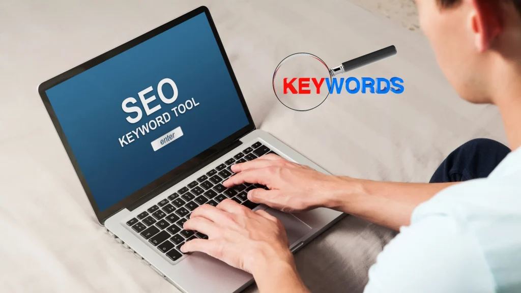 SEO keyword tool interface displayed on a laptop, with a person researching keywords for SEO.