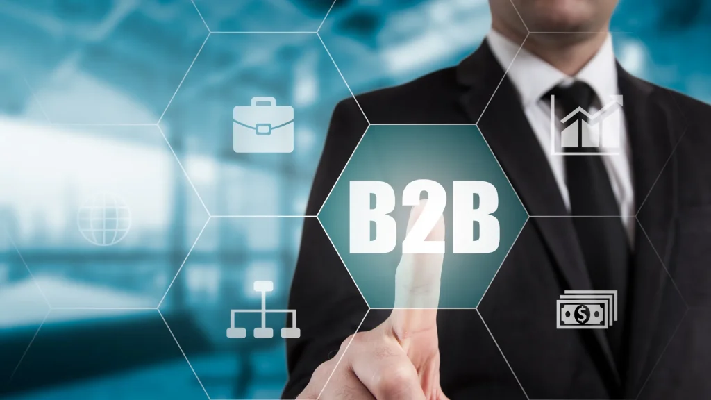 Business professional touching B2B icon, showcasing B2B digital marketing strategies in a modern workspace.